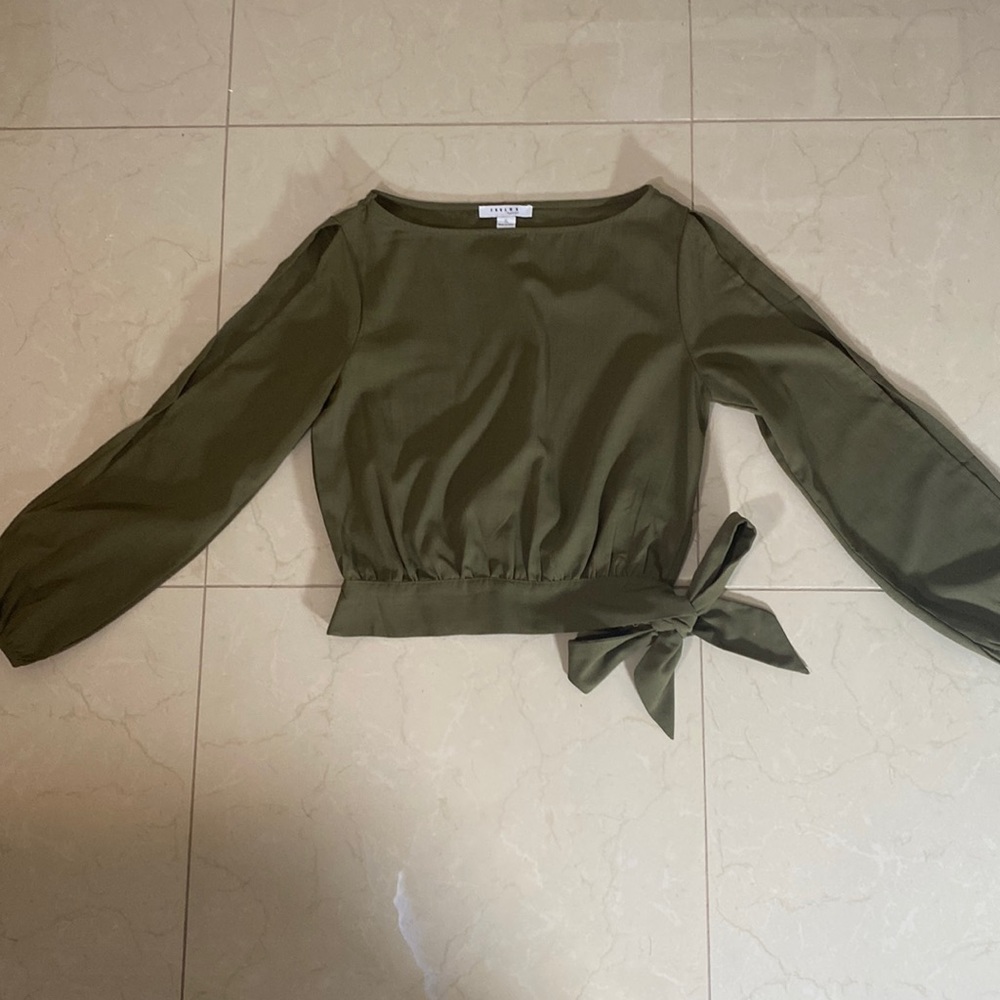 Cute slightly cropped peek-a-boo sleeve top. Tie waist detail.